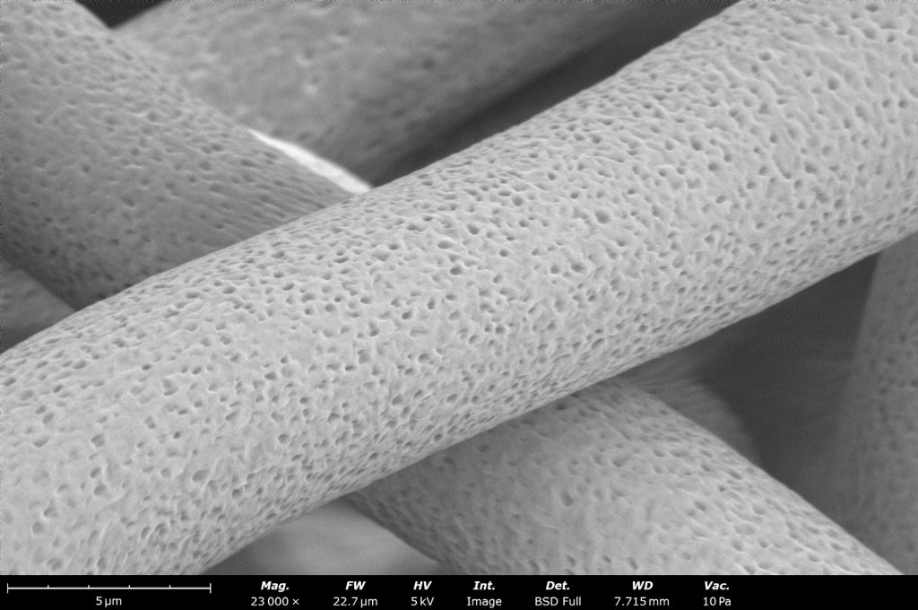 Upon close inspection, we see a porous structure on these 8 µm polycaprolactone (PCL) fibers. The small porosity allows cells to anchor and proliferate easier. These fibers were made using the Fluidnatek LE-50 using a rotating drum collector of 10 cm in diameter at 200 rpm.