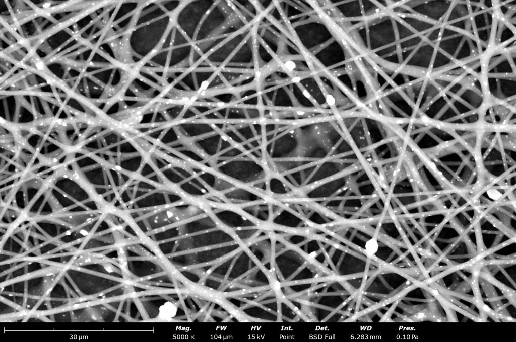 This SEM image shows the microstructure of poly(vinylidene fluoride-co-hexafluoropropylene) (PVDF-HFP) containing inorganic particles. Electrospinning offers the capability to generate fibrous materials containing different types of additives to improve sample properties based on application needs.